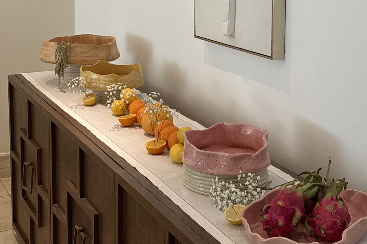 Sa7ne ceramic collection styled on a sideboard with fruit and gypsophila